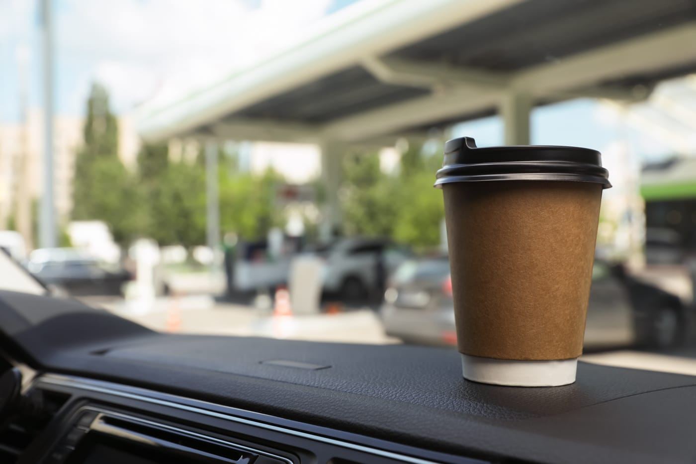 To-go coffee from Java Jack's Coffee Bar on a car dashboard