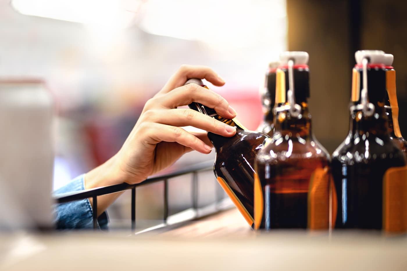Shopper reaching for a cold bottled drink in the elevated convenience store at Jack's Travel Center